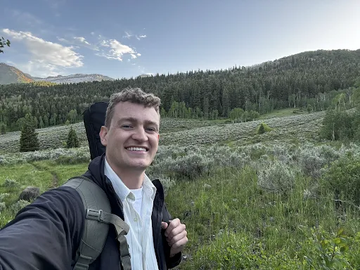 Will, the founder of Post-Mission Planner, hiking in the mountains